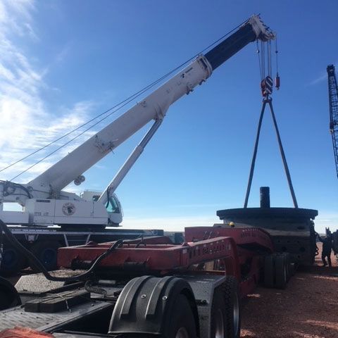 Moving a Heavy Equipment on The Truck — Gillette, WY — Black Hawk Crane & Rigging Inc