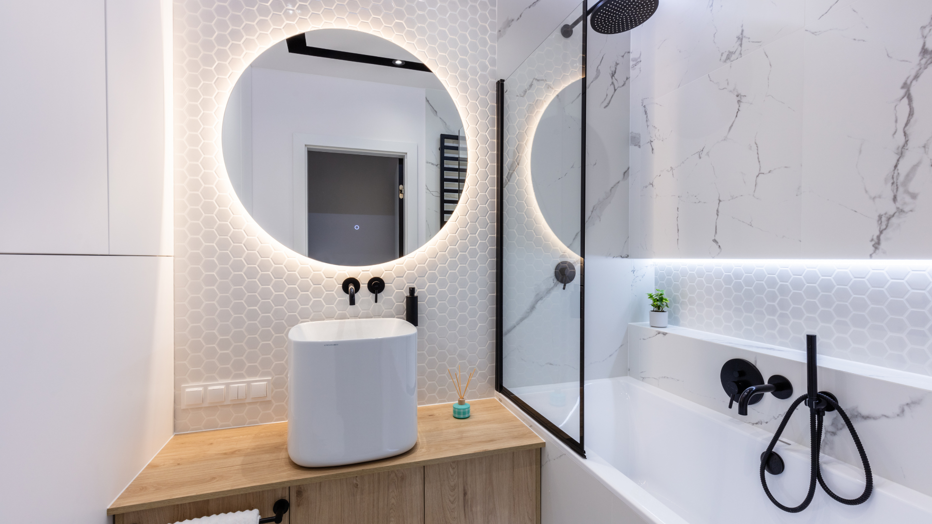 A bathroom with a sink , bathtub , shower and mirror.
