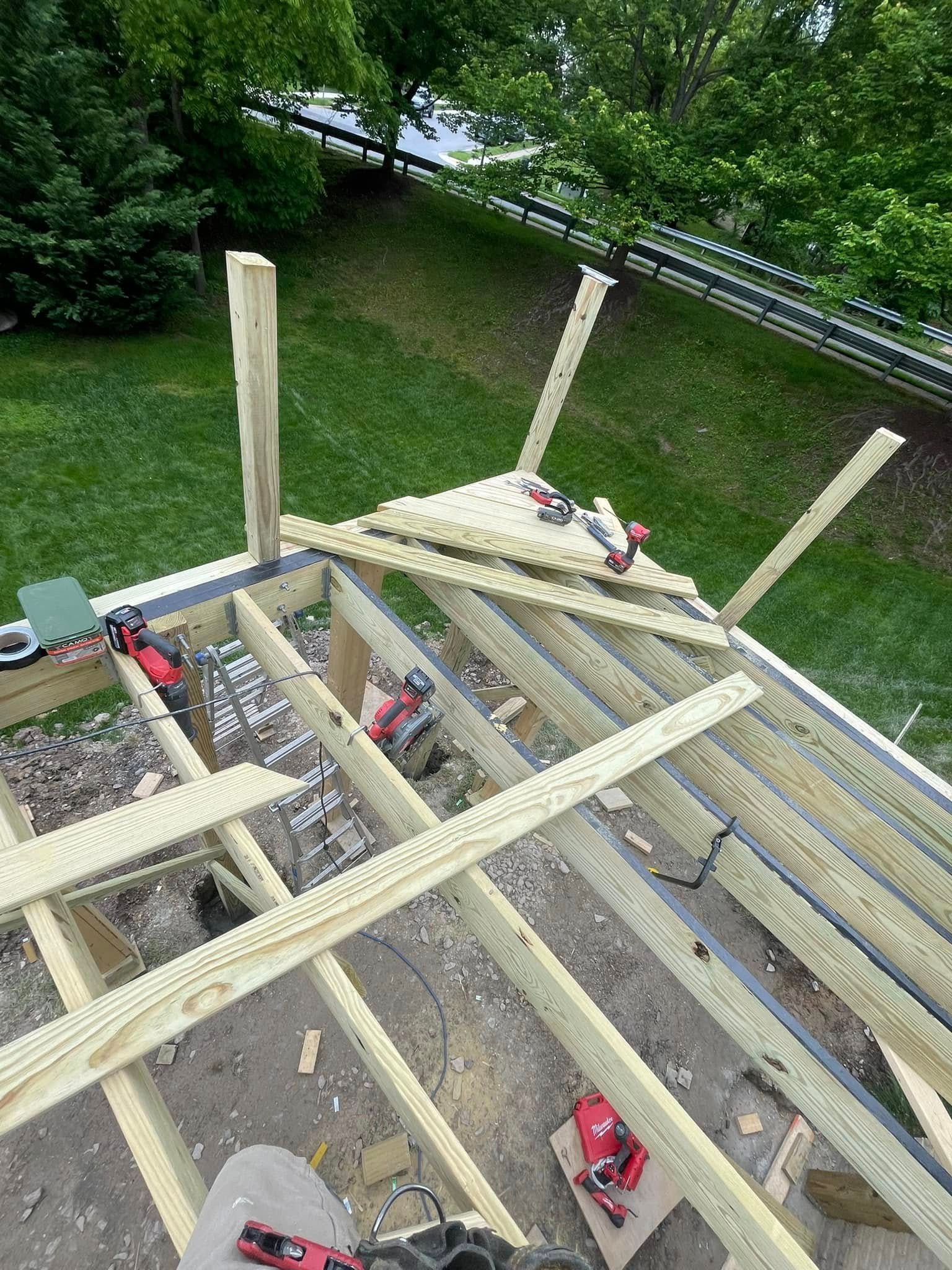 A wooden structure is being built in a backyard.