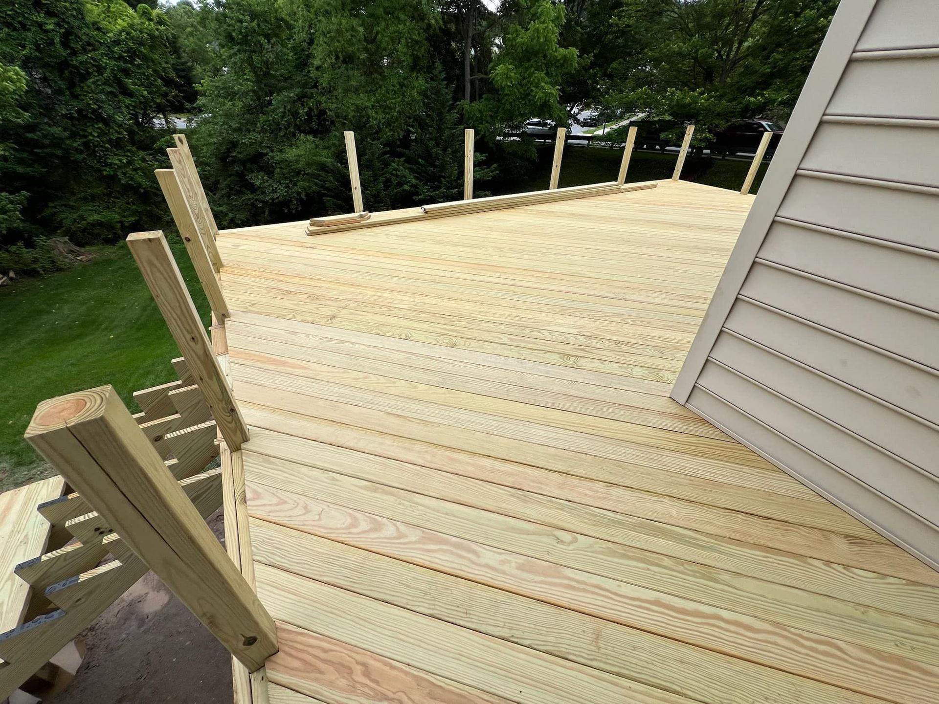 A wooden deck is being built on top of a house