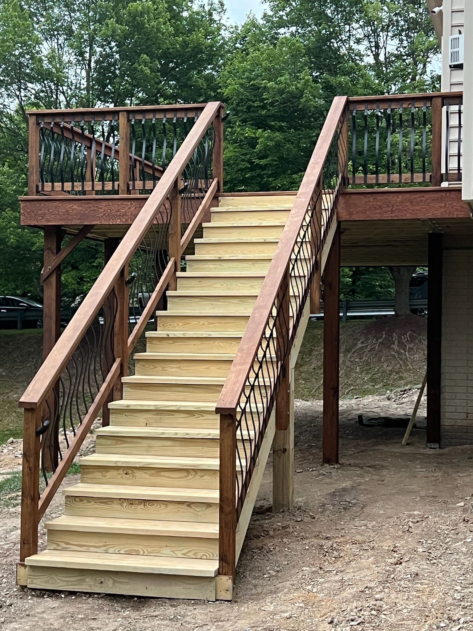 A wooden deck with stairs leading up to it.