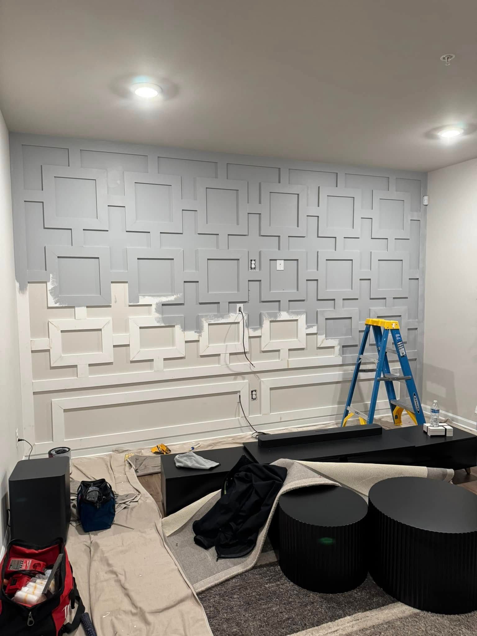 A living room is being remodeled with a ladder on the floor.