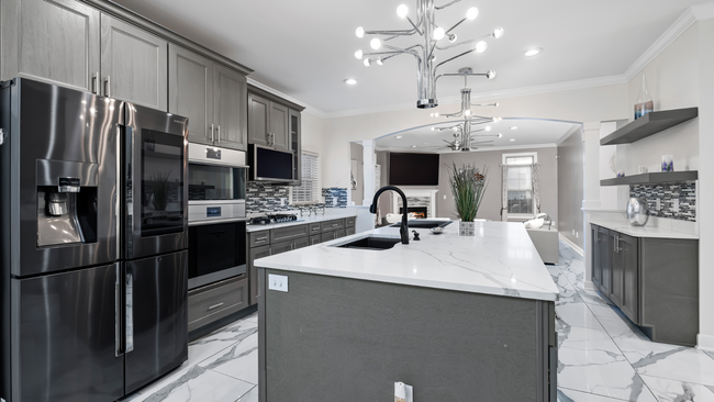 A kitchen with stainless steel appliances and a large island.