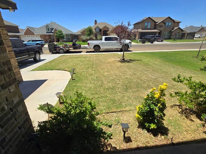 A white truck is parked in the driveway of a house.