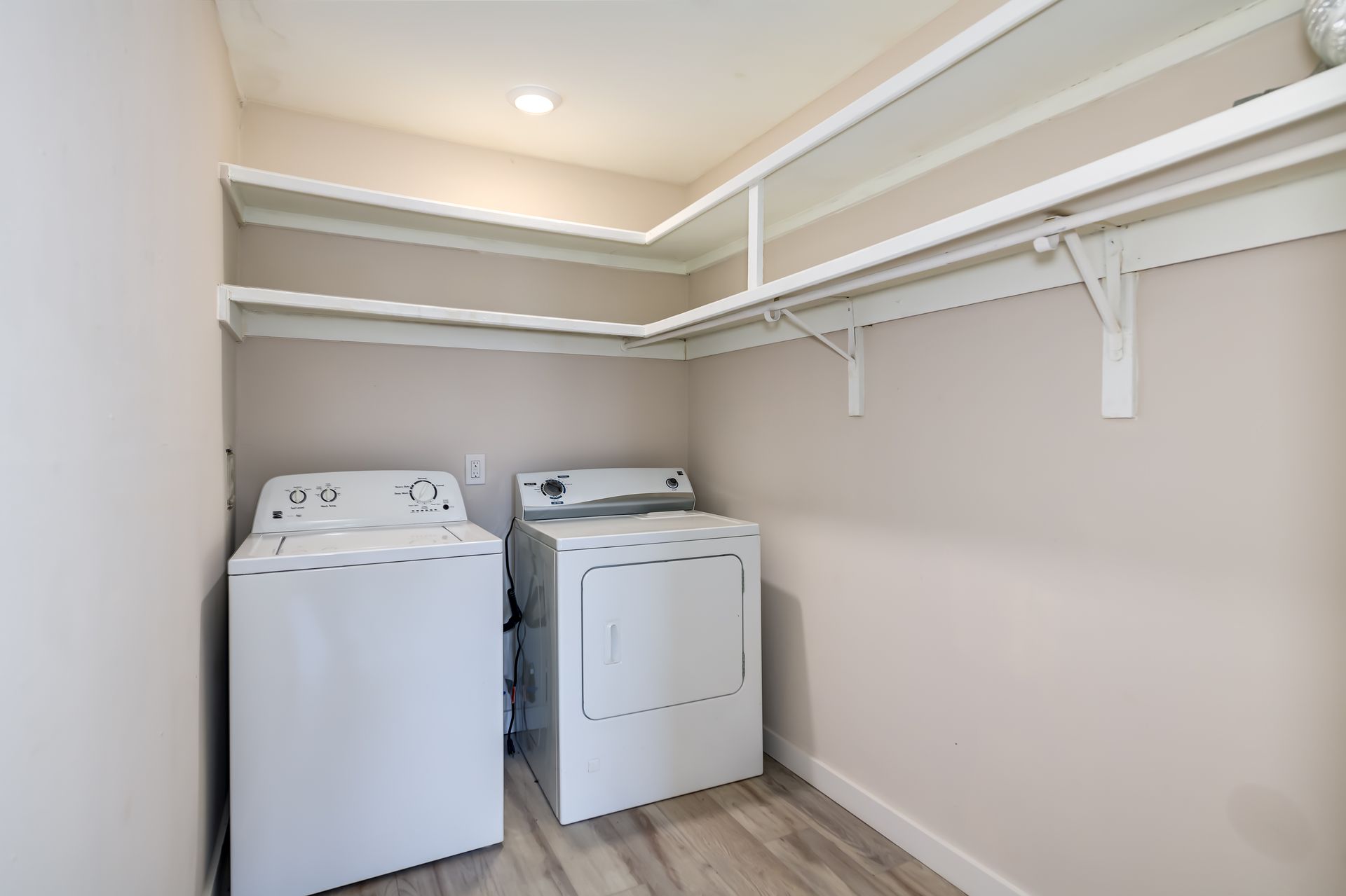 A laundry room with a washer and dryer in it.