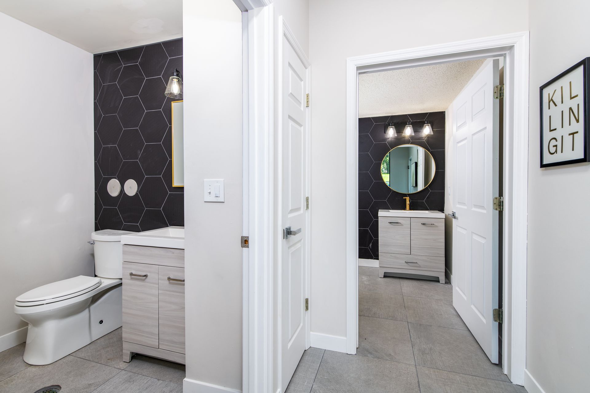 A bathroom with a toilet , sink and mirror.