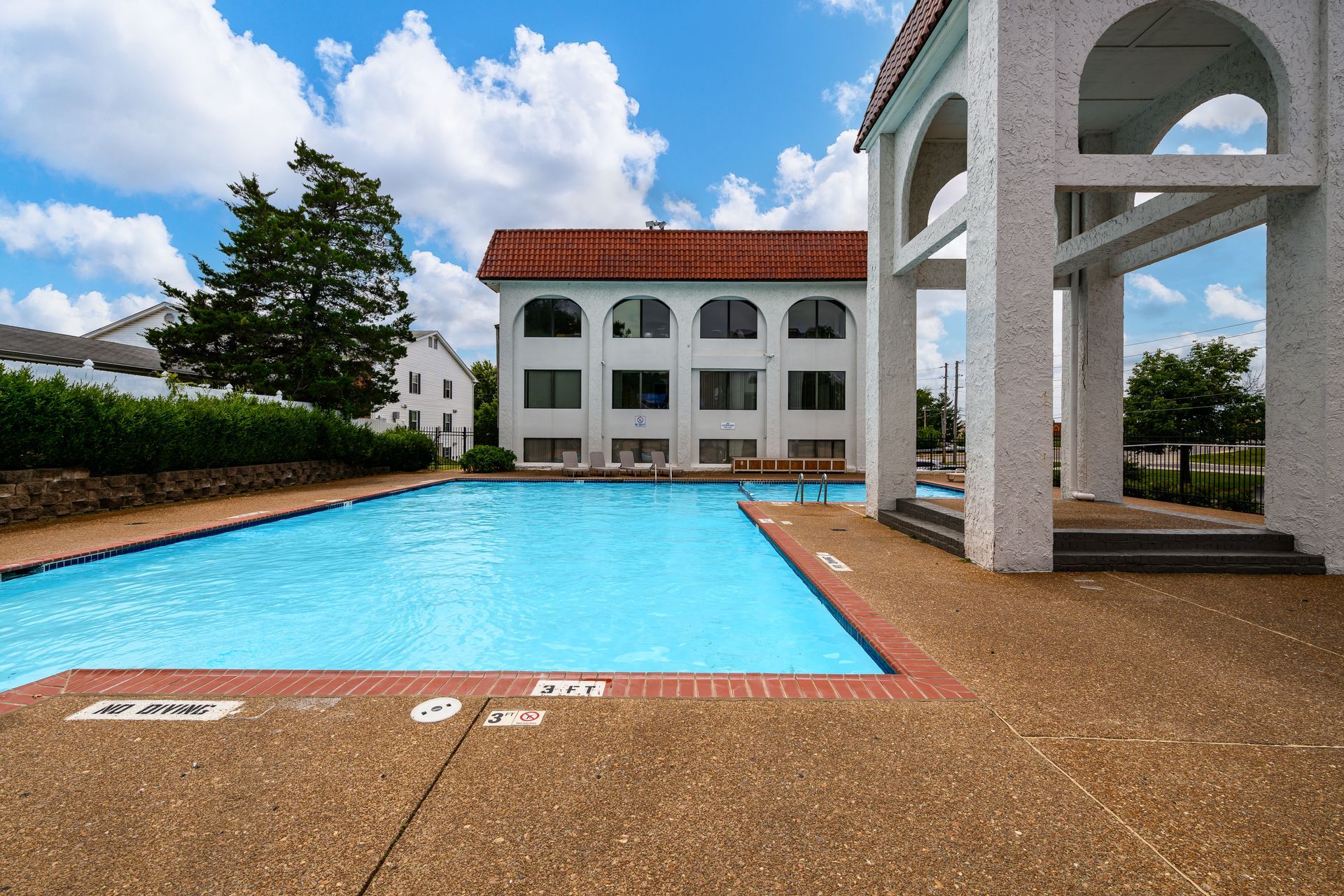 A large swimming pool with a building in the background