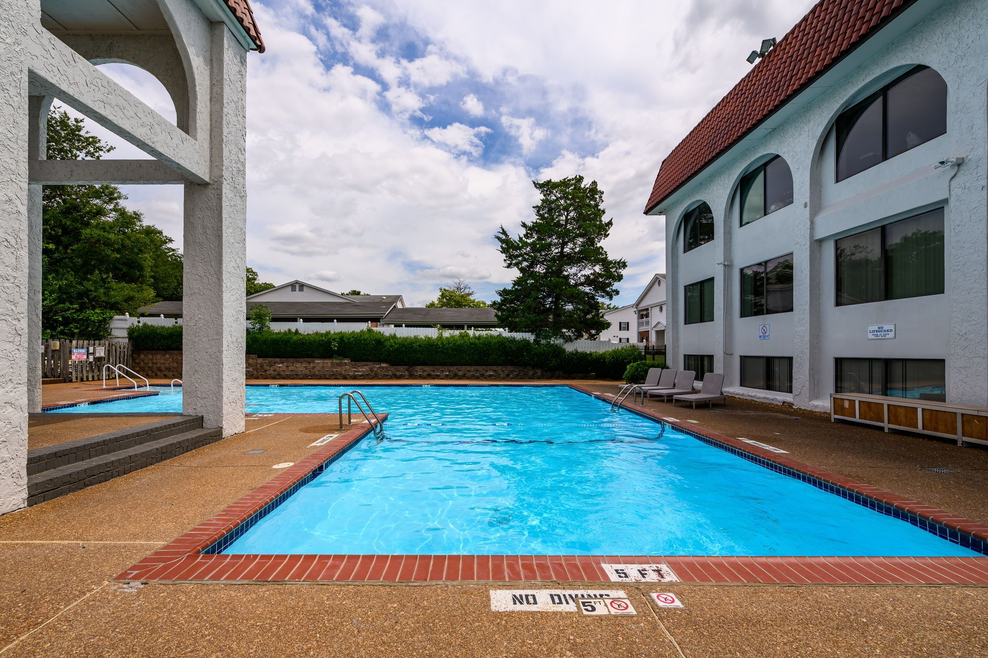 There is a large swimming pool in the middle of a building.