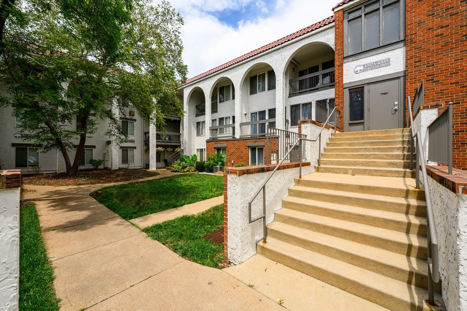 A large apartment building with stairs leading up to it.