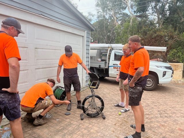 A Team of Men Working On A Driveway — BAS Plumbing & Drainage In Forresters Beach, NSW
