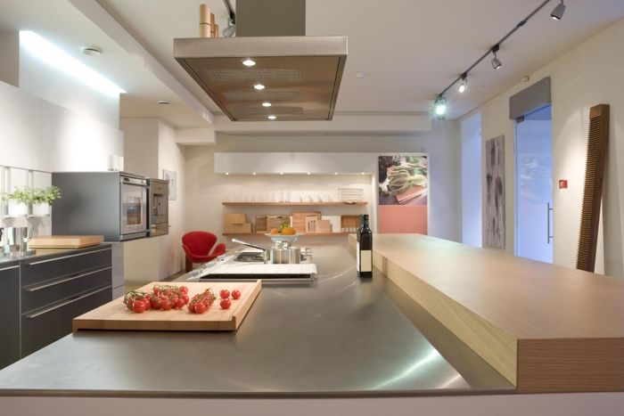 a kitchen room with long shiny countertop