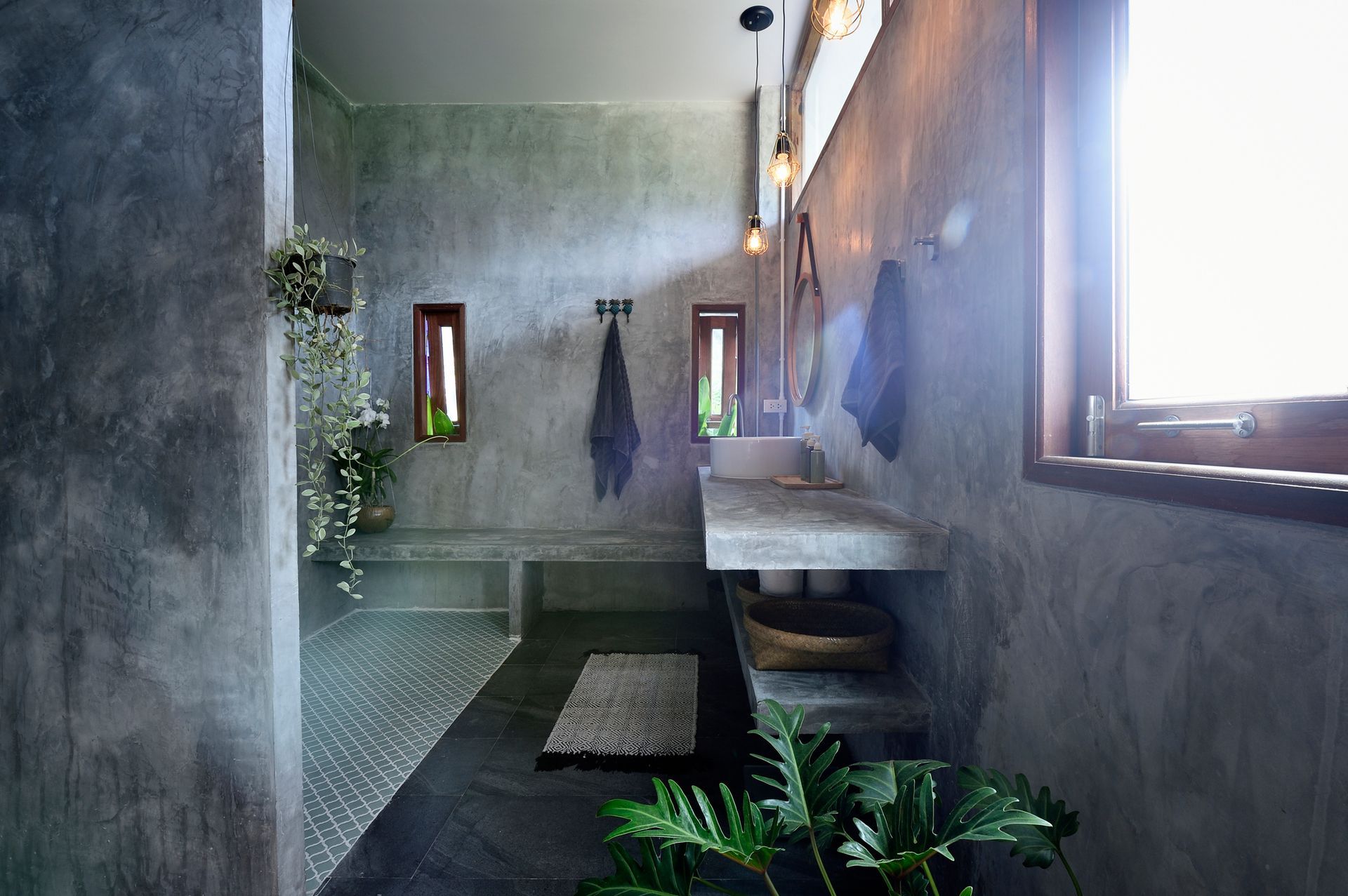 Luxury bathroom with tile and concrete walls.