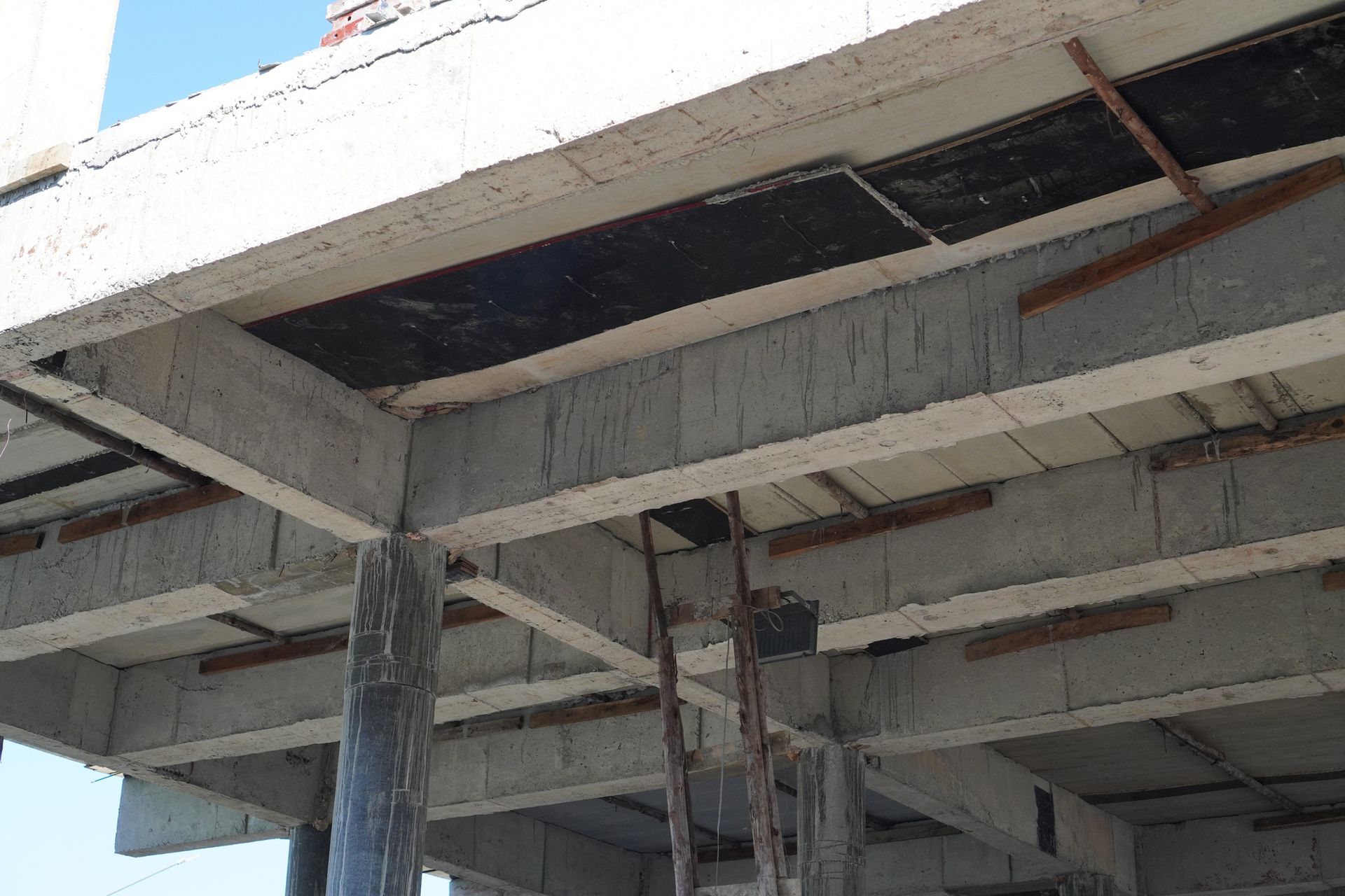 Concrete beams and columns with formwork in place during building construction.