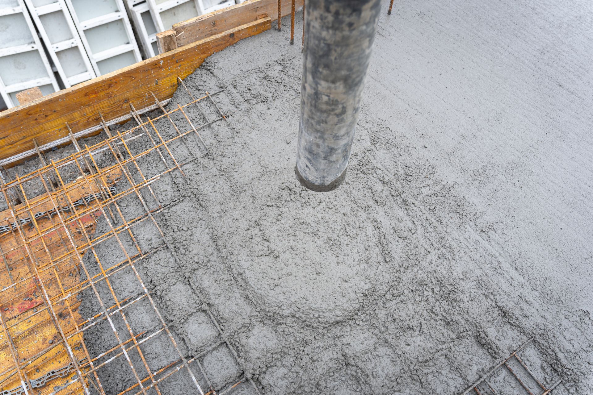 Reinforcing bars with wet cement in the process of pouring Reinforcing bars with wet cement in the process of pouring