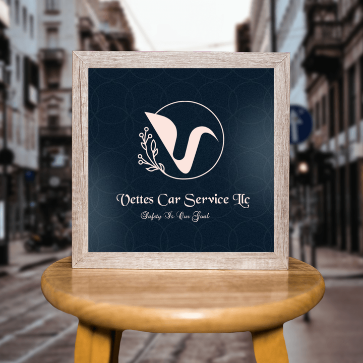 A framed logo for nettes car service sits on a wooden stool