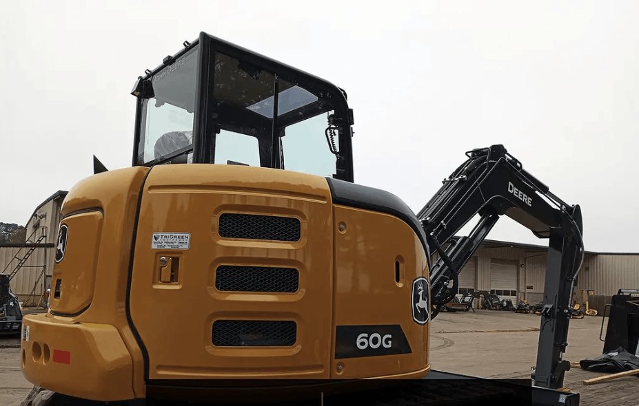 A yellow excavator is parked in a parking lot.
