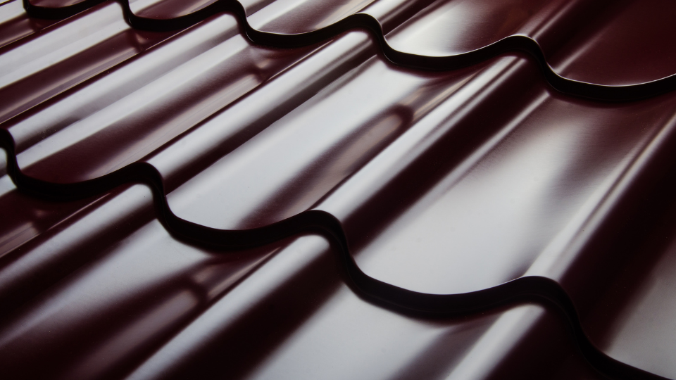 A close up of a maroon roof with a wave pattern