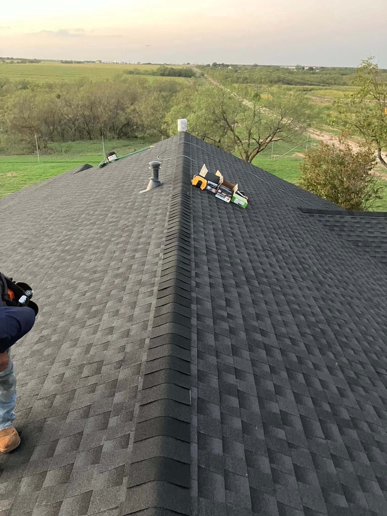 A man is working on the roof of a house.