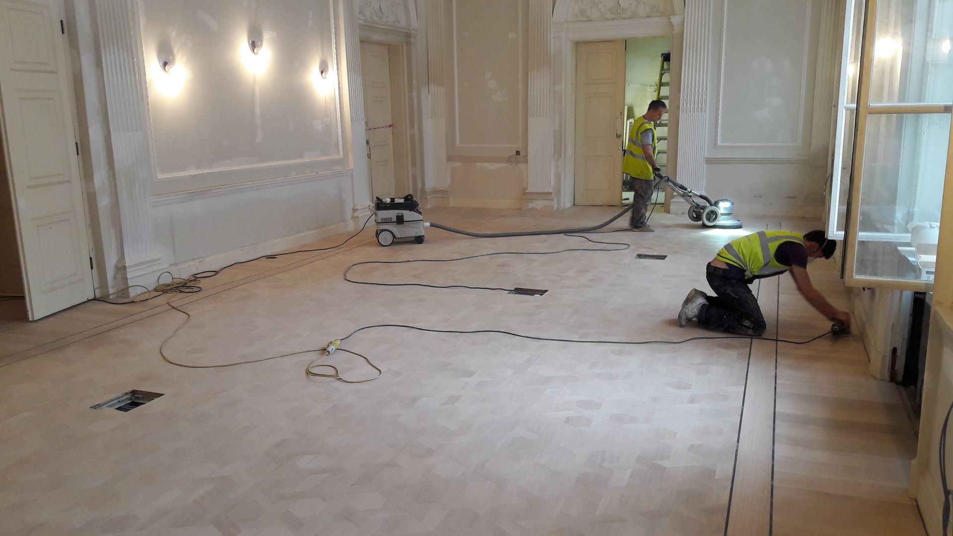 Sanding newly fitted Bespoke Coloured Oil Flooring for the Prince of Qatar's residence in Mayfair