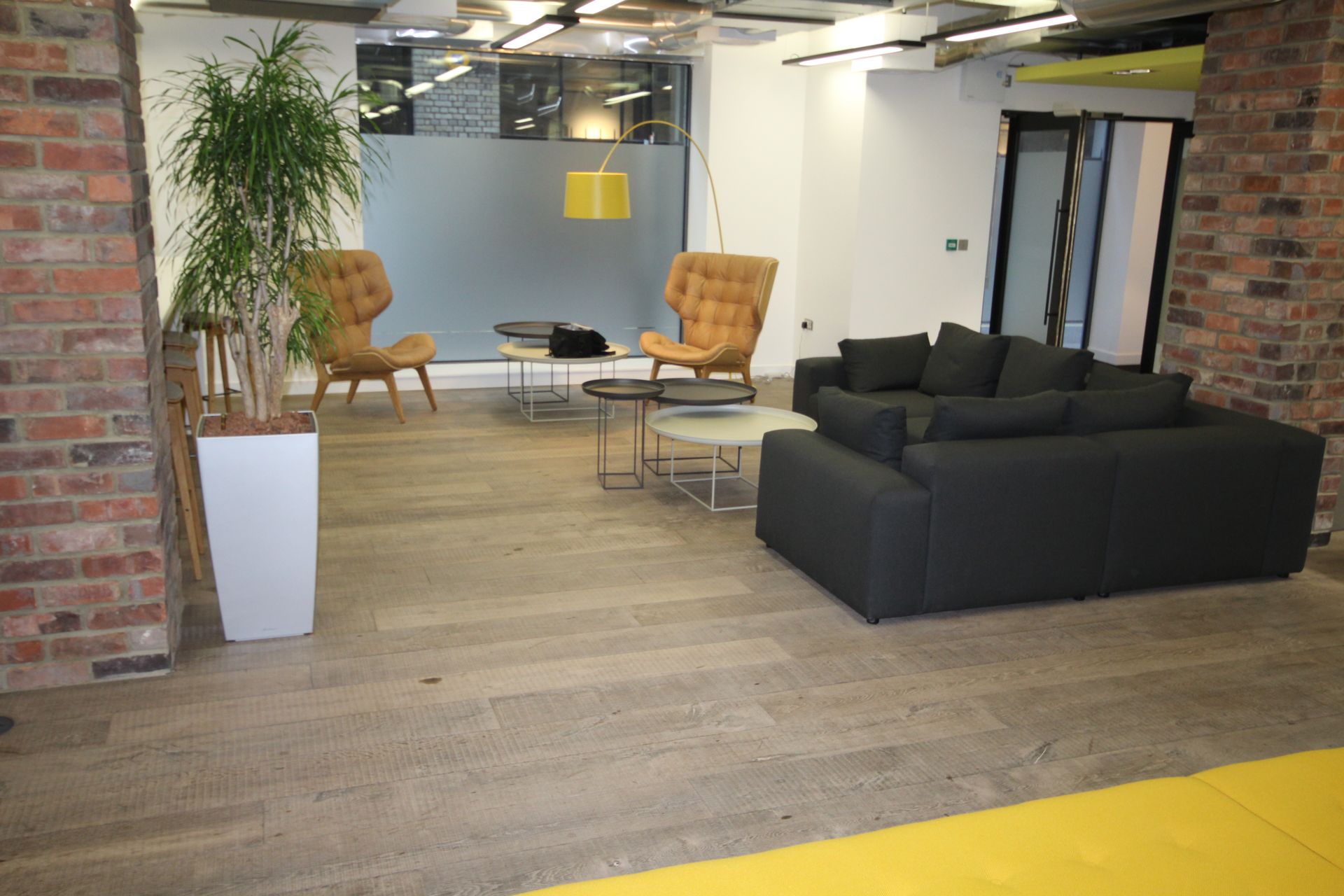 Stylish living space with dark sofa seating and a pair of matching side chairs