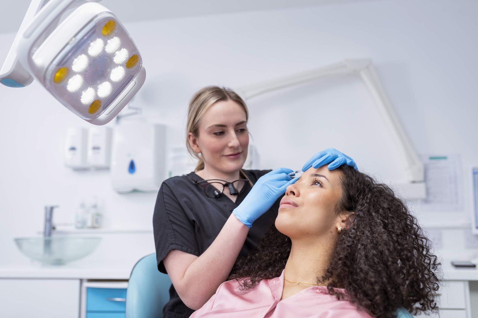 Cosmetic nurse injecting botox.