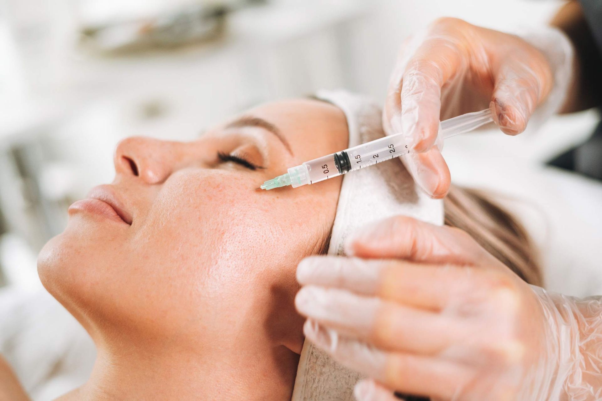 Woman getting cosmetic injections in her face.