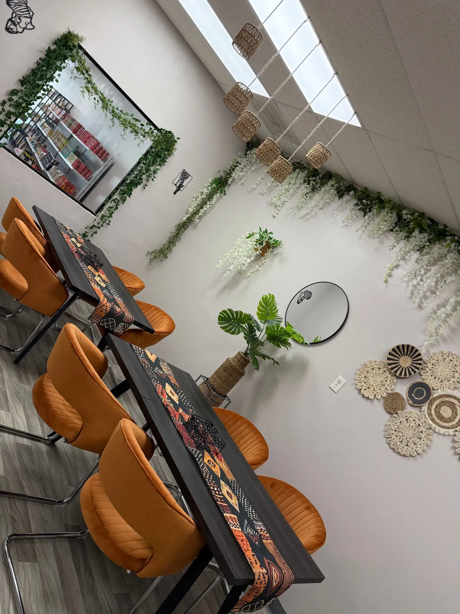 A room with tables and chairs and a mirror