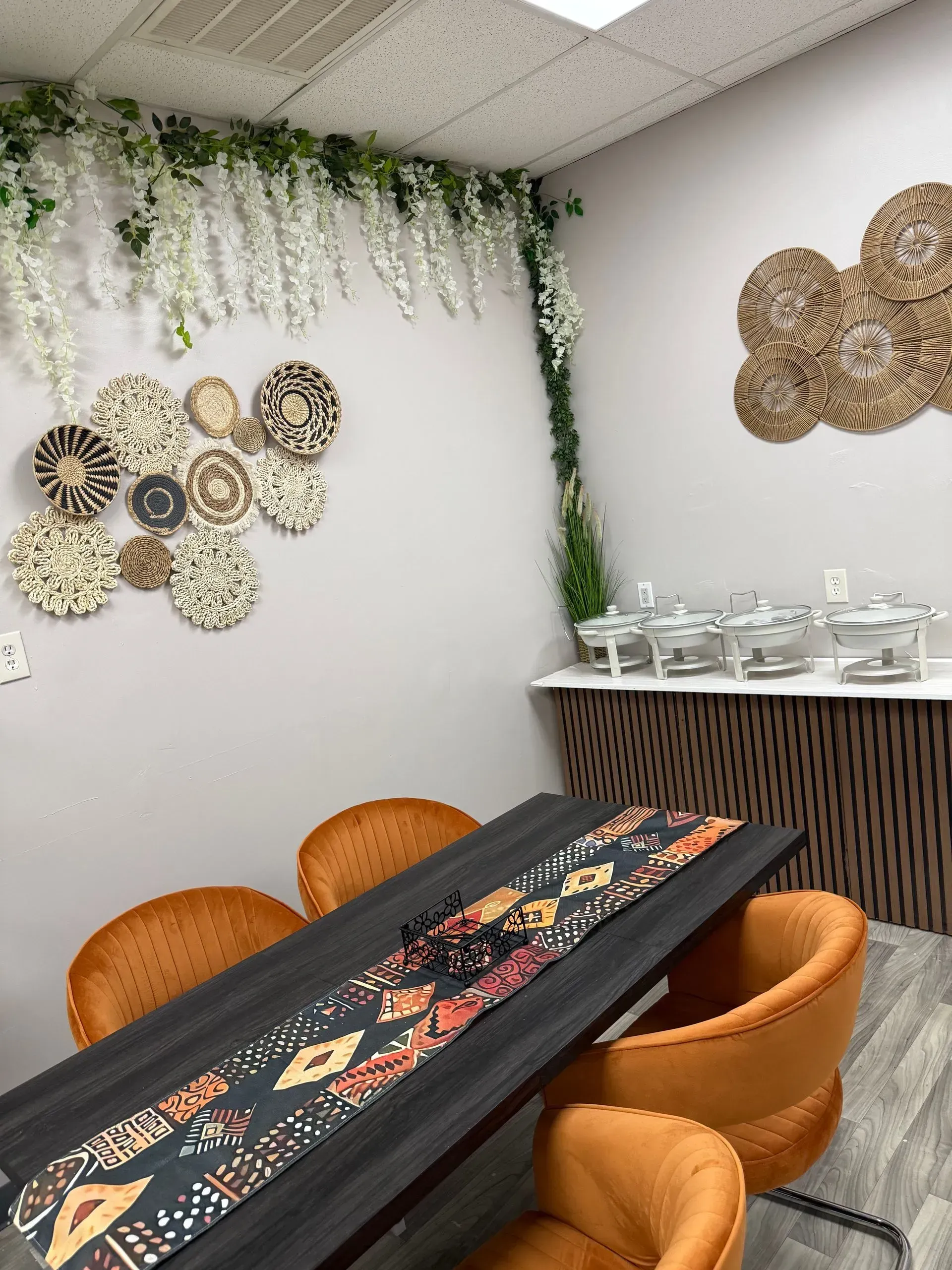 A dining room with a table and chairs and a buffet.