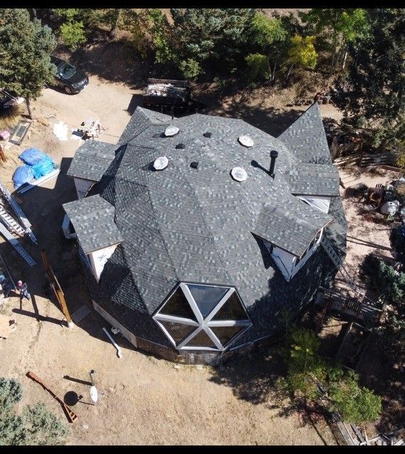 An aerial view of a dome shaped house surrounded by trees – Evergreen, CO - Elevated Roofing