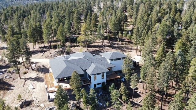 An aerial view of a house in the middle of a forest – Evergreen, CO - Elevated Roofing