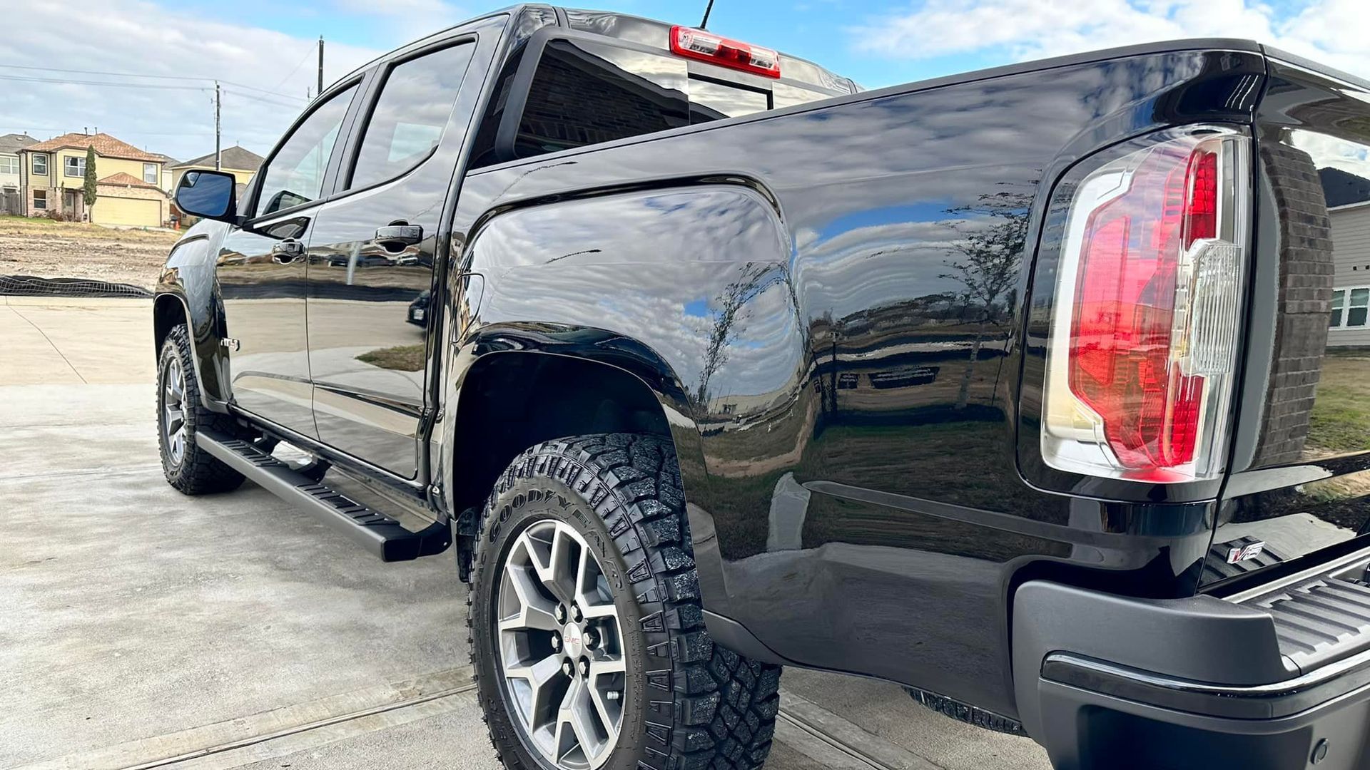 Black pickup truck parked outside on a sunny day.