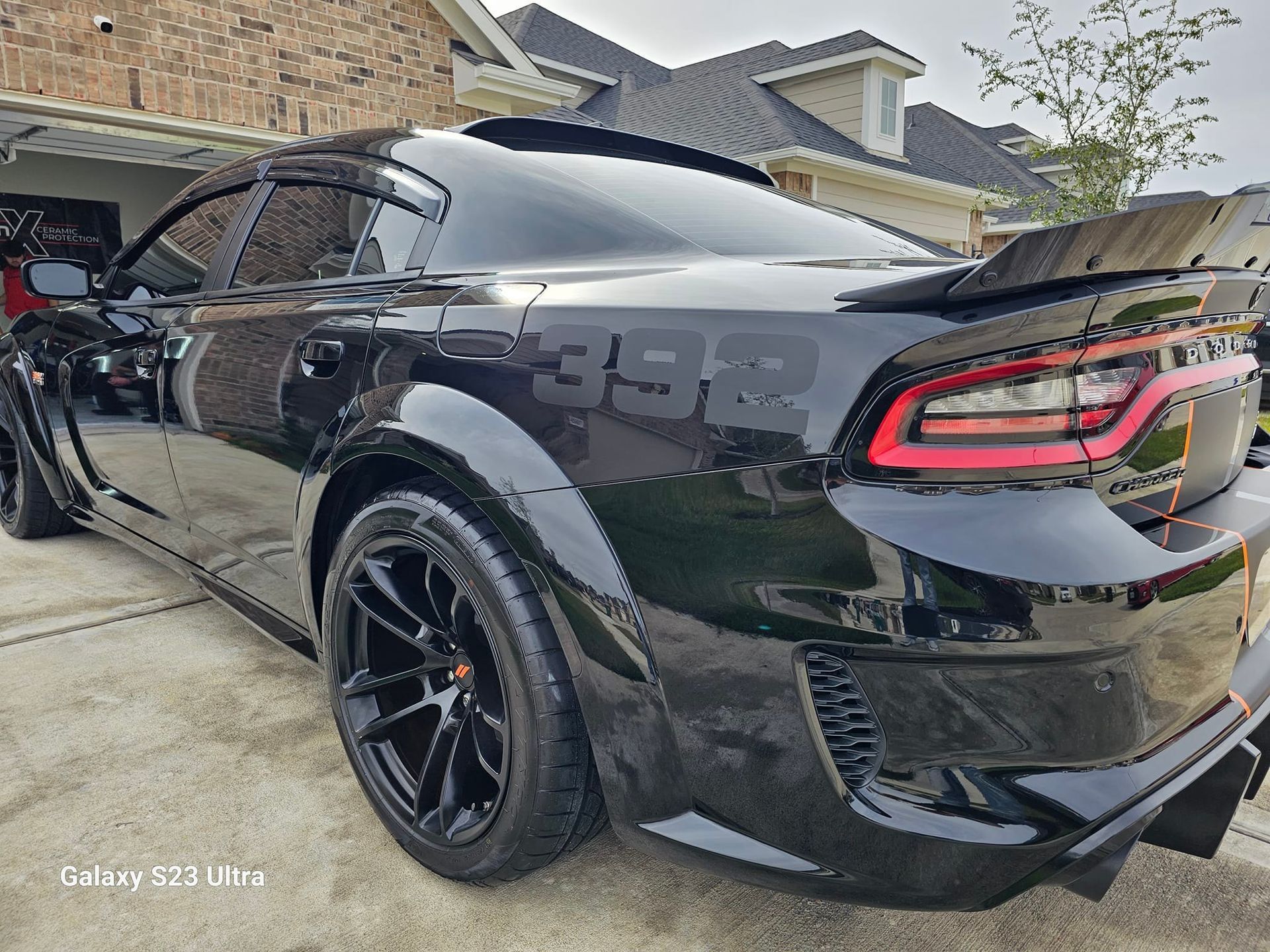 Black Dodge Charger with custom rear wing and fender flares. 