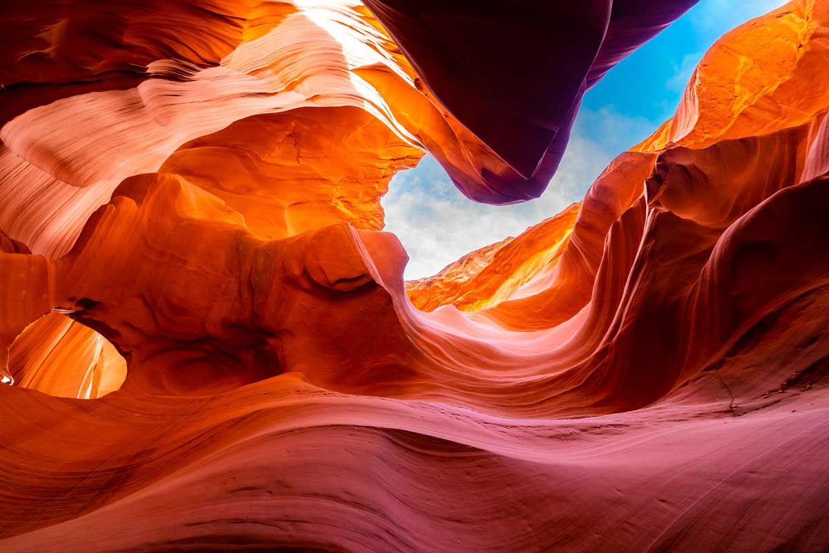 Stunning view of a slot canyon with vibrant red and orange rock formations, showcasing the natural beauty of Antelope Canyon.