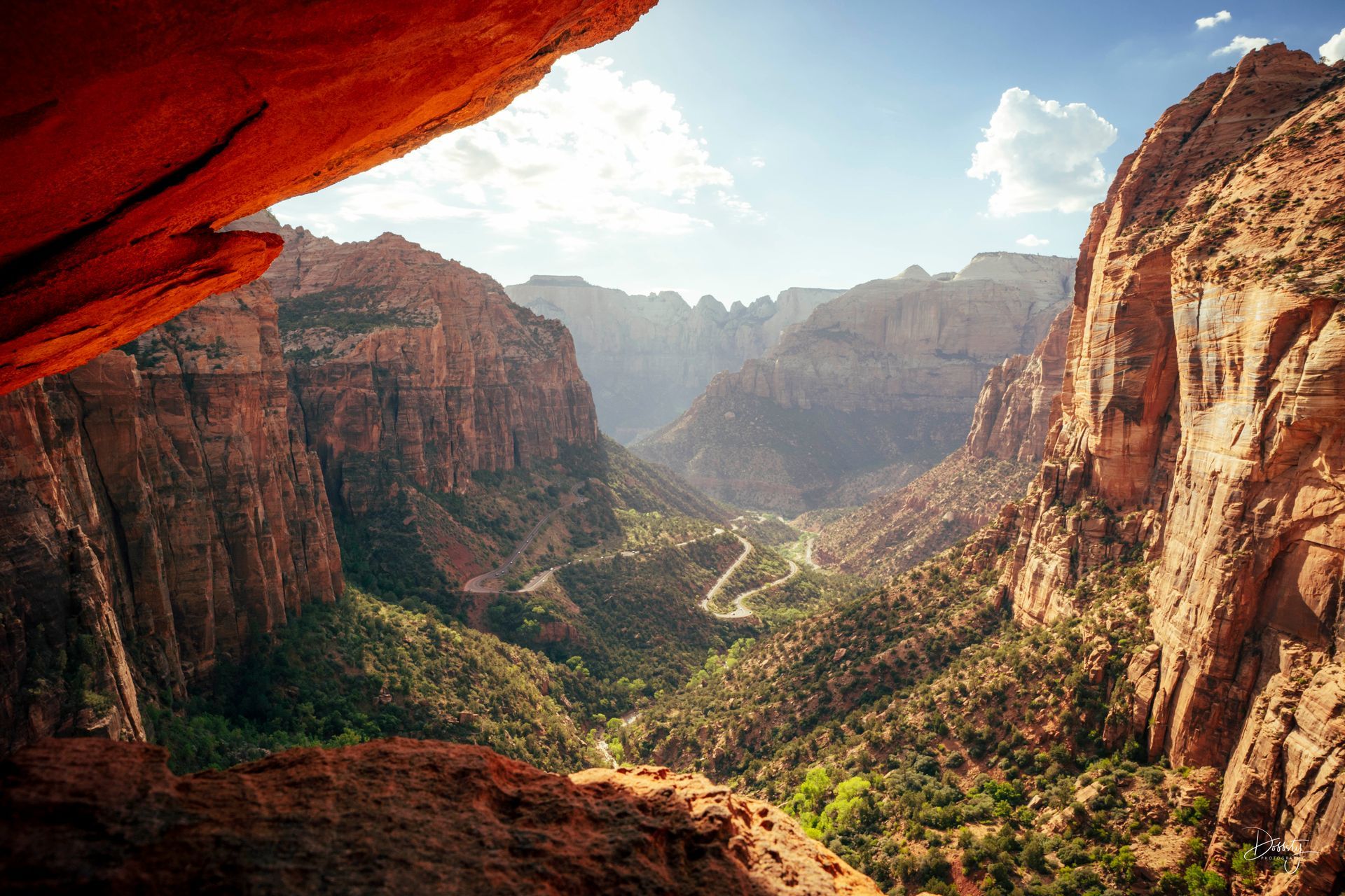 A stunning view of the winding road through Zion National Park's majestic canyons. Canyon Overlook Trail Cave