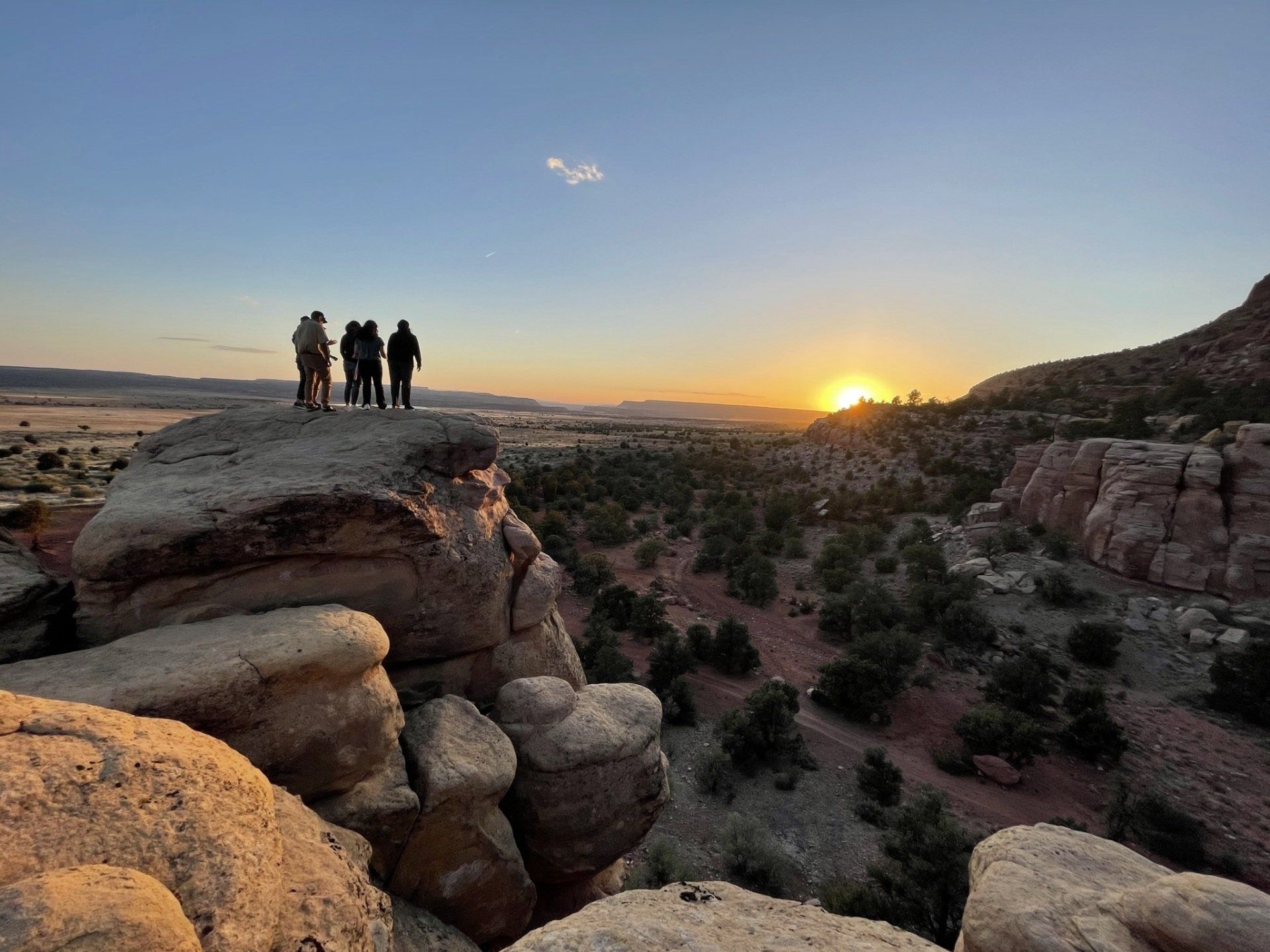 Group of friends watching the sunset from an overlook near Zion Glamping Adventures, capturing the beauty of the landscape.