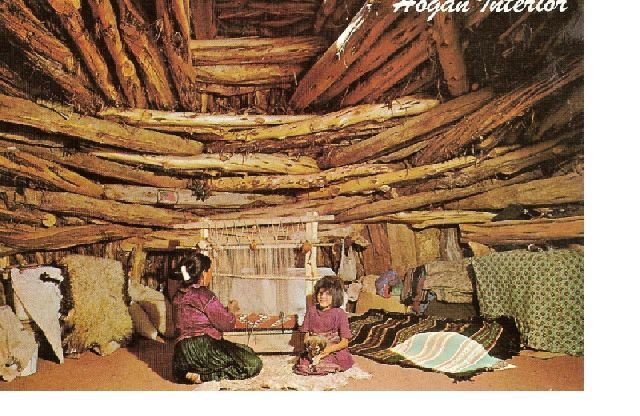 An old photograph of a traditional Navajo hogan interior, with two children sitting and weaving.