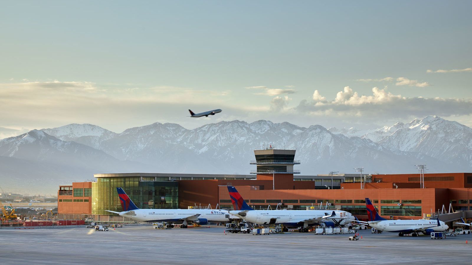 airplay takes off from Salt Lake City airport with the snow capped mountains in the background