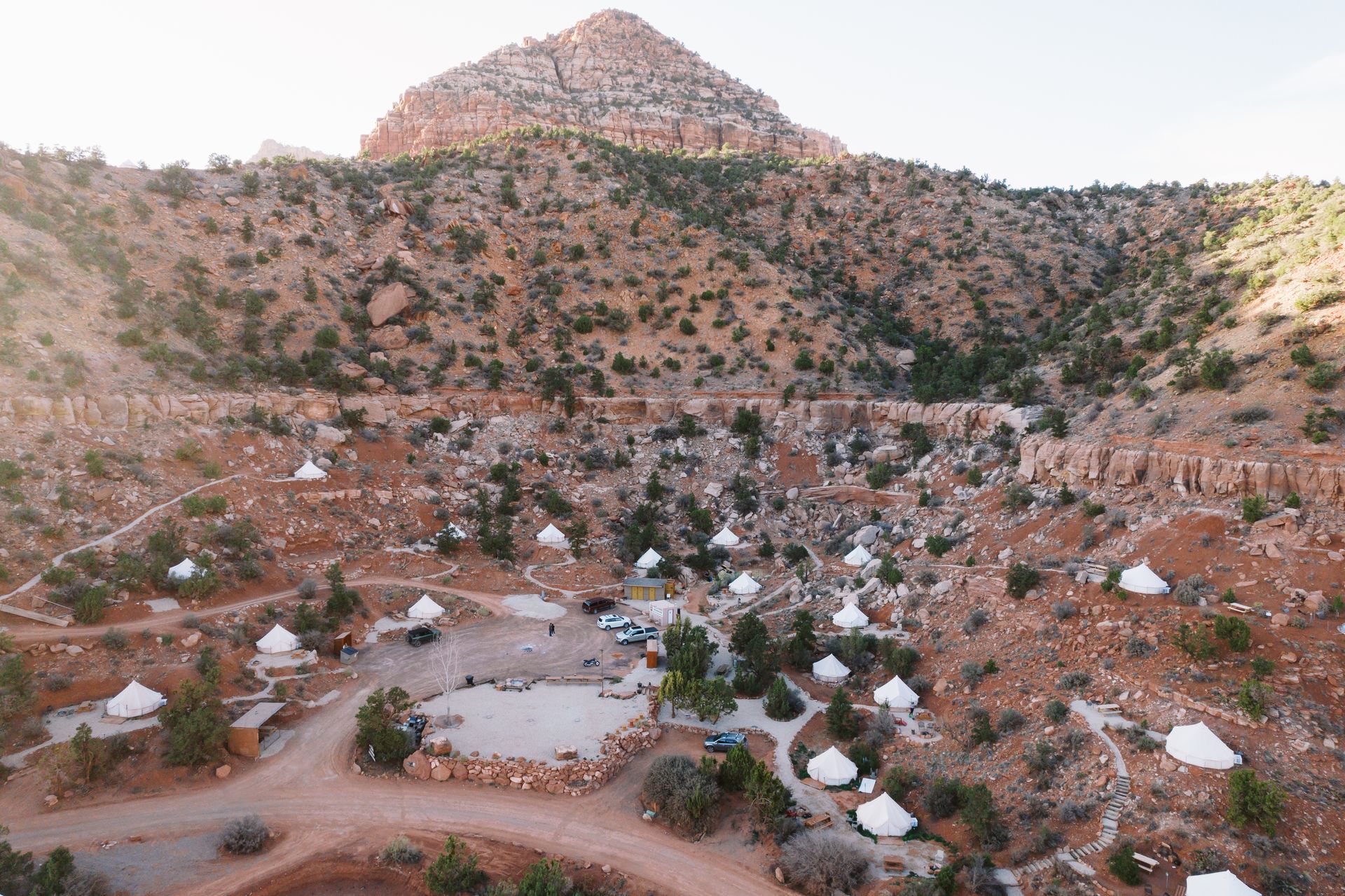 Aerial view of Zion Glamping Adventures campsite nestled in the rugged terrain, showcasing tents and scenic mountain backdrop