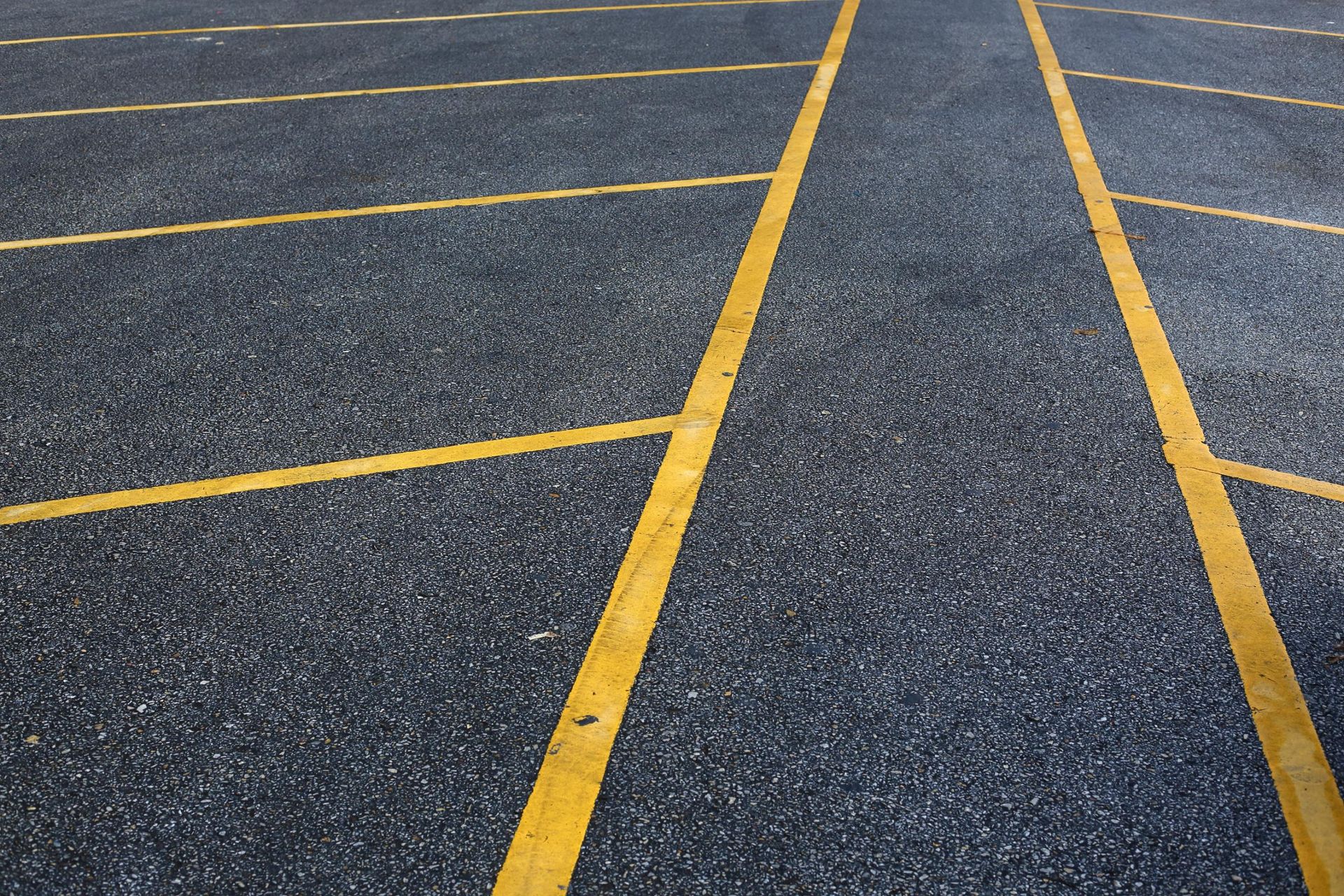 A close up of a parking lot with yellow lines