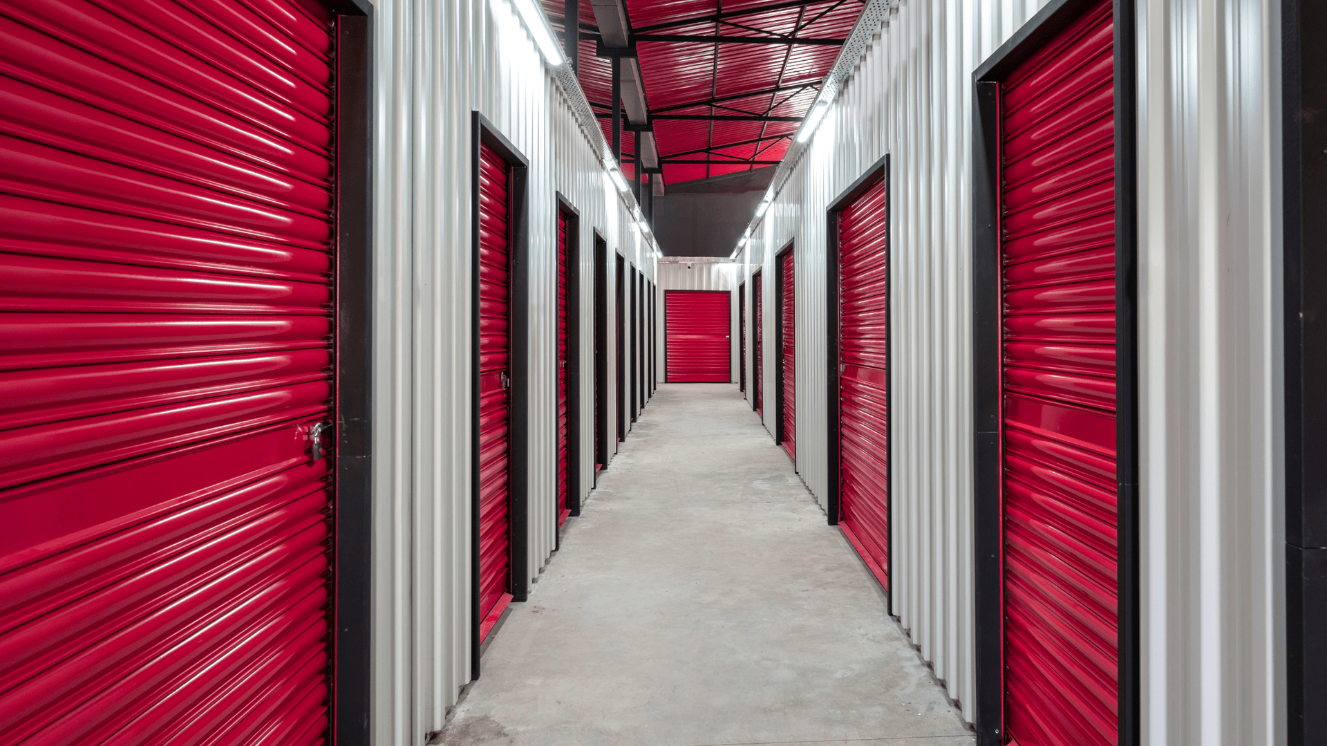 Red storage unit doors line a long hallway — Gympie Southside Mini Storage in Southside, QLD