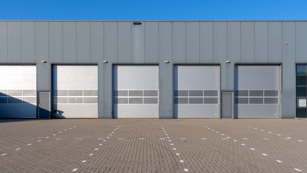 Gray Industrial Building With Four Closed Garage Doors  — Gympie Southside Mini Storage in Southside, QLD
