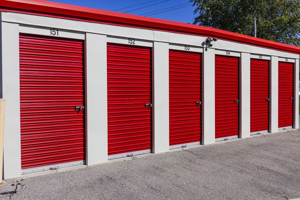 Red storage unit doors in a row, with numbers 151, 150, 149, 148, 147, and 146. — Gympie Southside Mini Storage in Southside, QLD