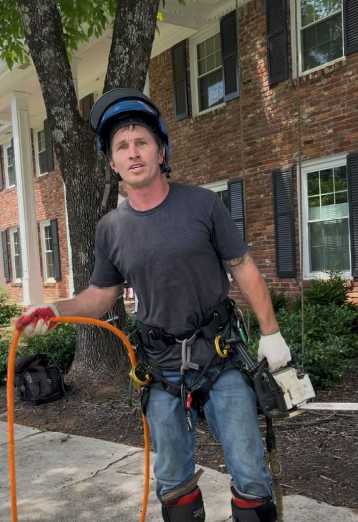 Nathan the owner in all safety gear after helping the crew remove a large tree