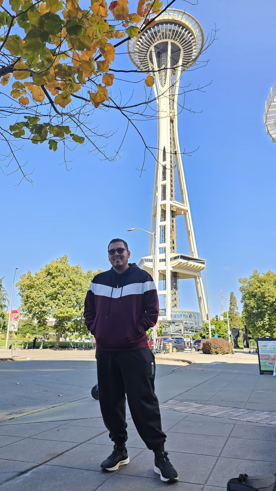 A man is standing in front of a very tall tower.