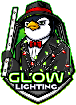 A penguin in a suit and tie is holding a glowing stick.