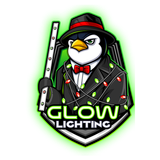 A penguin in a suit and tie is holding a glowing stick.