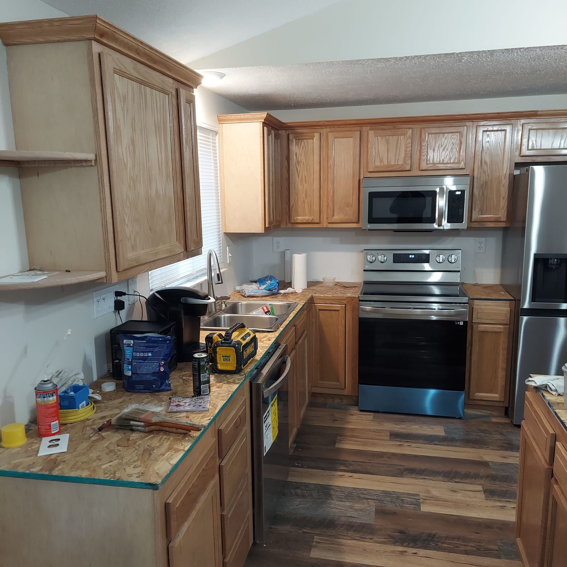 A kitchen with stainless steel appliances and wooden cabinets