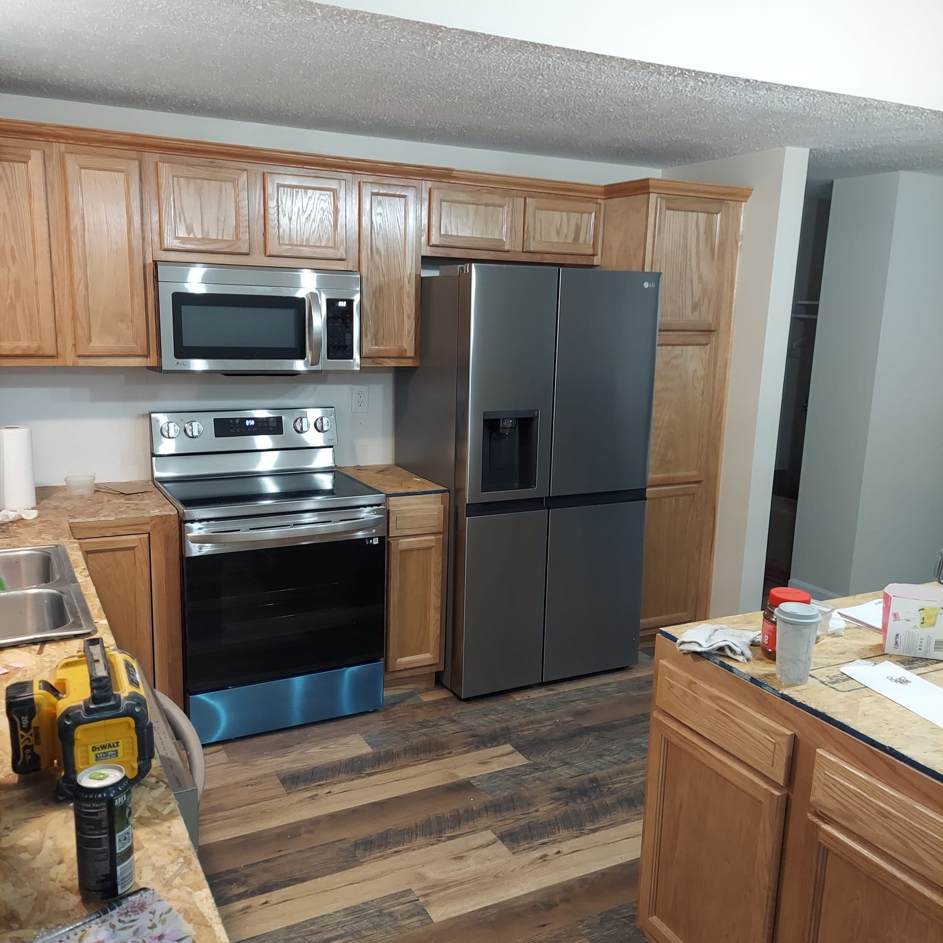 A kitchen with stainless steel appliances and wooden cabinets