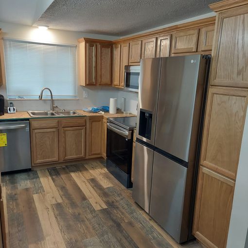 A kitchen with stainless steel appliances and wooden cabinets