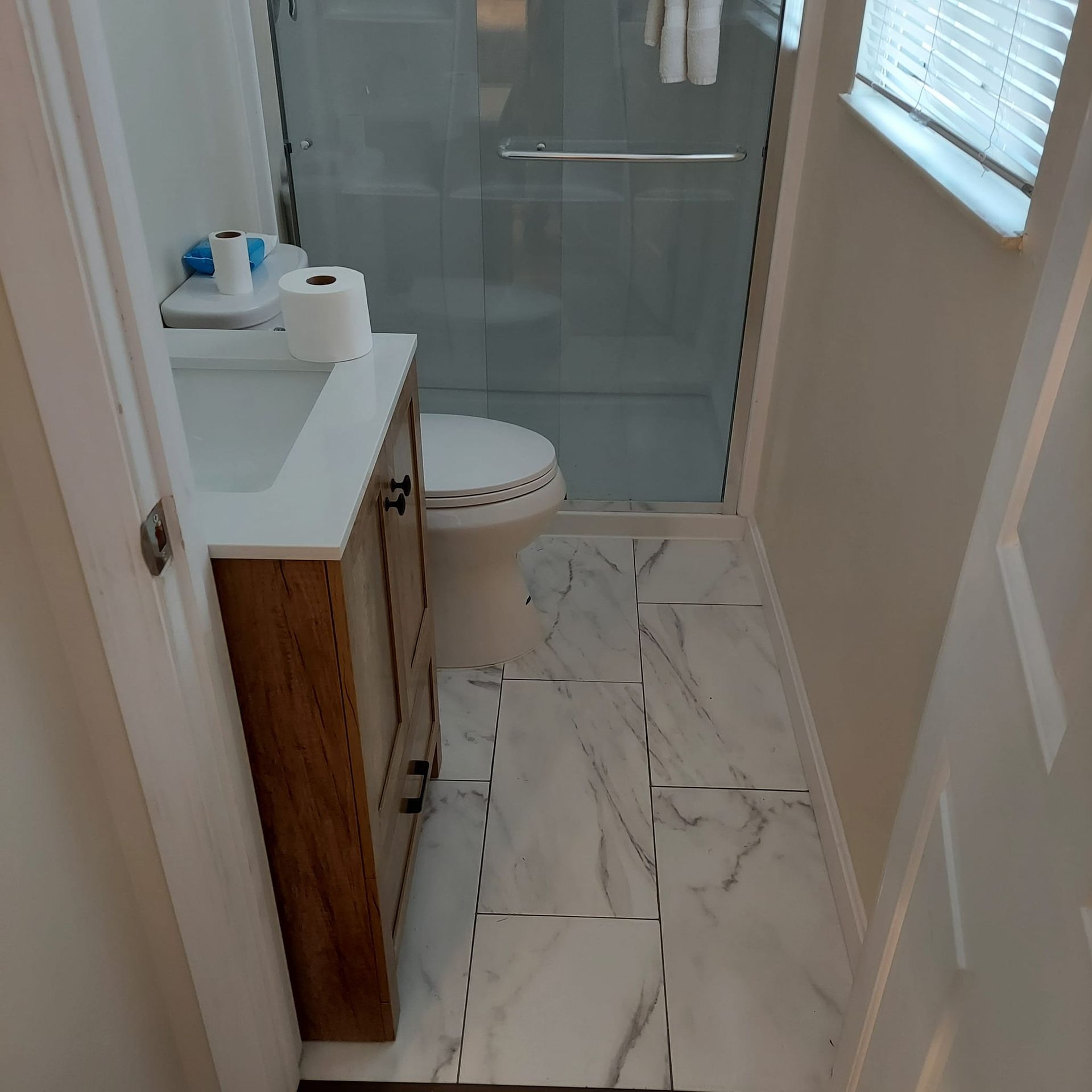 A bathroom with a toilet , sink , and shower.